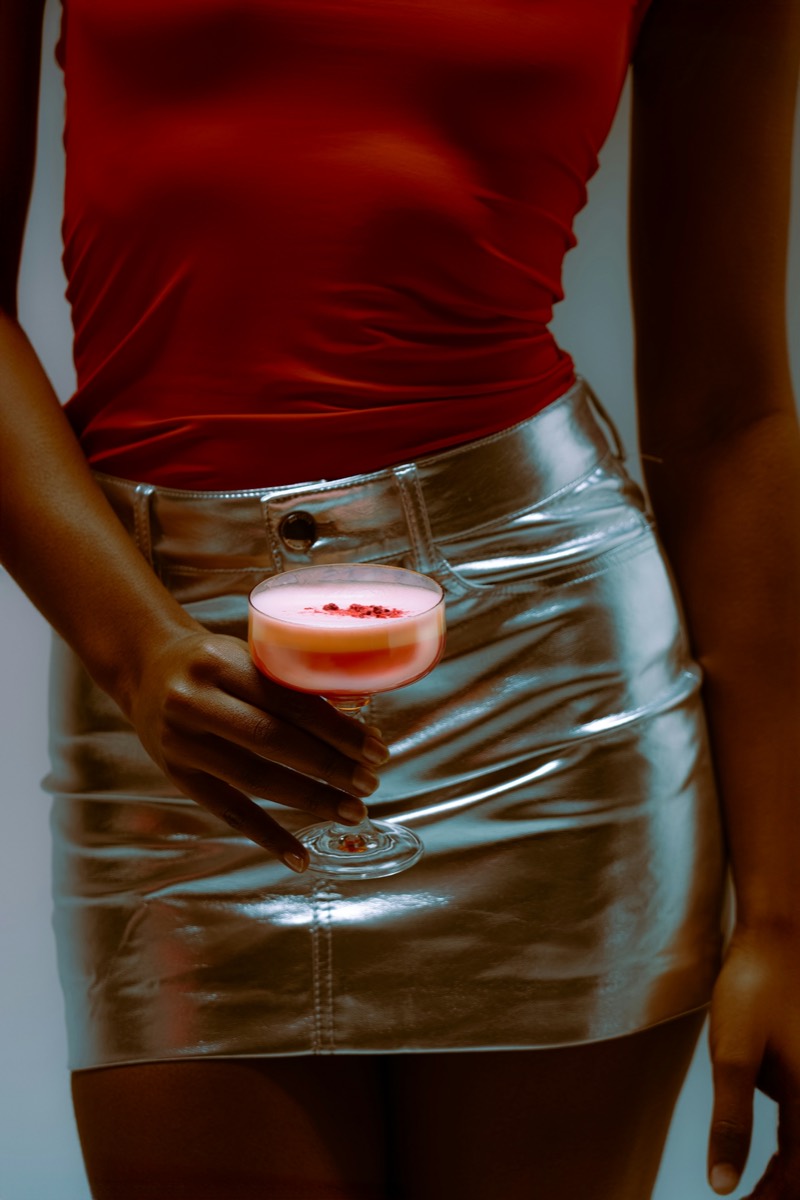 red top, silver mini, a blush sour in hand